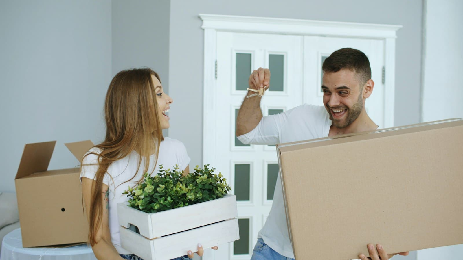 Couple moving boxes into their first home